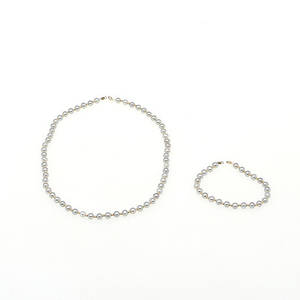 PÄRLCOLLIER samt ARMBAND med lås samt mellanpärlor i 14K rödguld.