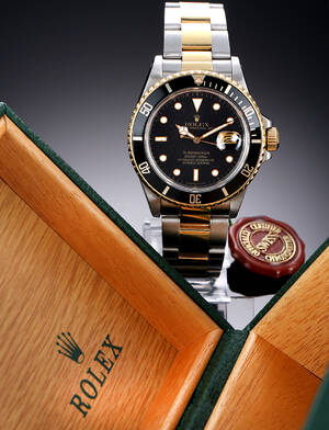 Rolex Submariner. Herreur i 18 kt. guld og stål med sort skive, ca. 1987